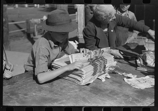 Untitled photo, possibly related to: Newsboys getting the papers just after the arrival of the morning train, Montrose, Colorado. While there is a daily paper in this town here as in most towns of this size, the papers from the larger cities are popular