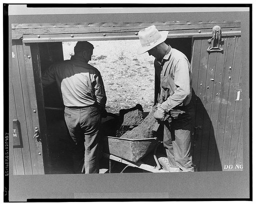 Loading gold ore concentrate into freight cars of narrow gauge railroad, Ouray, Colorado