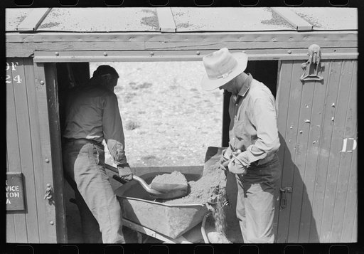 Untitled photo, possibly related to: Loading gold ore concentrate into freight cars of narrow gauge railroad, Ouray, Colorado