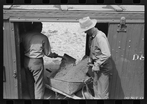 Untitled photo, possibly related to: Loading gold ore concentrate into freight cars of narrow gauge railroad, Ouray, Colorado
