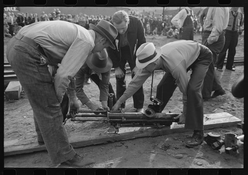 Judges inspecting drill which will be used in miners power drilling contest at Labor Day celebration, Silverton, Colorado