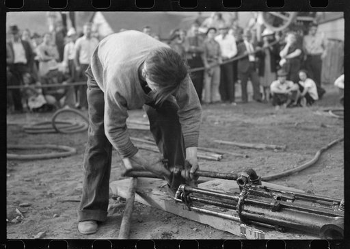 Untitled photo, possibly related to: Judges inspecting drill which will be used in miners power drilling contest at Labor Day celebration, Silverton, Colorado