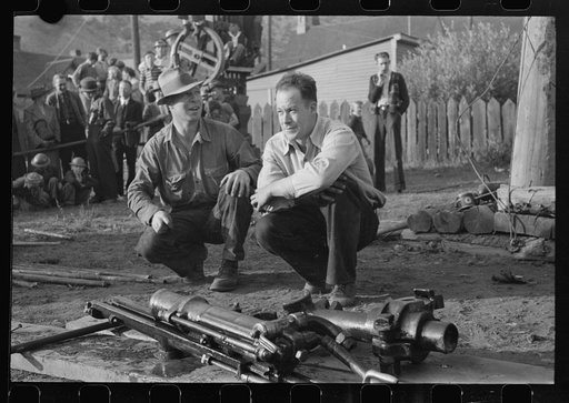 Untitled photo, possibly related to: Miner attaching airhose to power drill which he will use in drilling contest, Labor Day celebration, Silverton, Colorado
