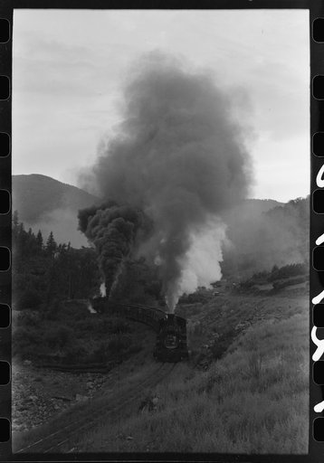 Train coming up the valley on a narrow gauge track, Ouray County, Colorado. Notice the two engines