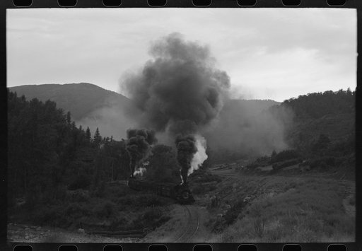 Untitled photo, possibly related to: Train coming up the valley on a narrow gauge track, Ouray County, Colorado. Notice the two engines