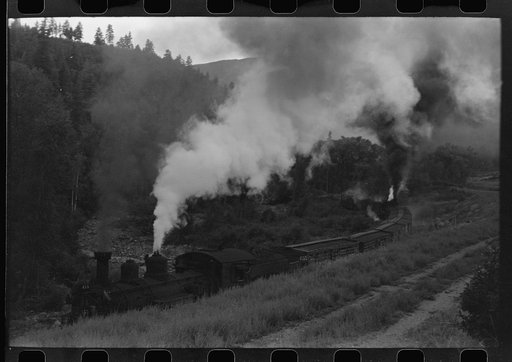 Untitled photo, possibly related to: Train coming up the valley on a narrow gauge track, Ouray County, Colorado. Notice the two engines