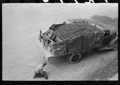 Untitled photo, possibly related to: Unloading gravel to be used in mine building construction, Ouray County, Colorado