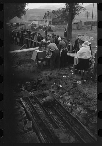 Untitled photo, possibly related to: Barbecue pits and people standing in line to be served at the free barbecue at Labor Day, Ridgway, Colorado