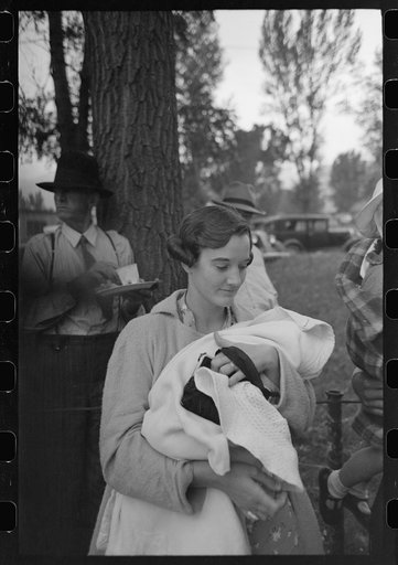 Woman and her baby waiting in line for barbecue on Labor Day at Ridgway, Colorado