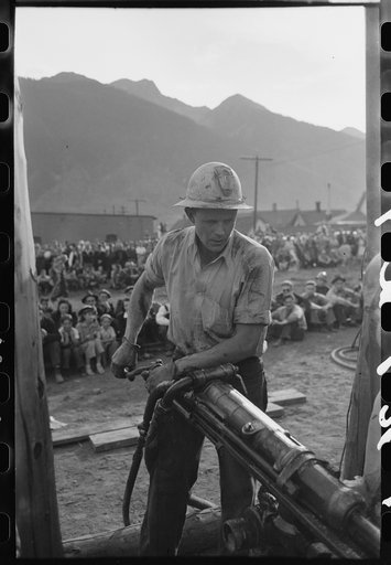 Gold miner operating hand drill in hand-drilling contest on Labor Day, Silverton, Colorado