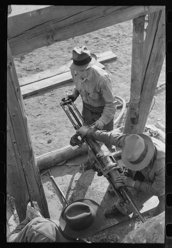 Team of two gold miners operating hand drill in contest on Labor Day, Silverton, Colorado