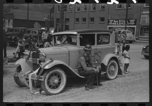 Miners sitting on decorated car during Labor Day celebration, Silverton, Colorado