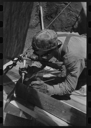Untitled photo, possibly related to: Spot welder at work on Shasta Dam. Shasta County, California