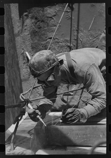Spot welder at work on Shasta Dam. Shasta County, California