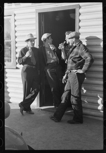 Shasta Dam construction workers drinking beer at entrance to bar. Central Valley, California