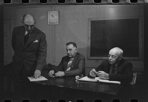 Officer and speaker at meeting of farmers with agricultural agent. Placer County, California