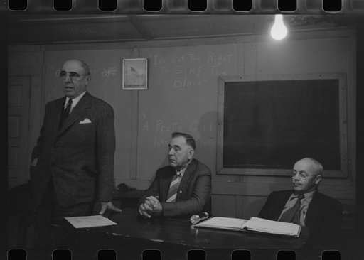 Officer and speaker at meeting with agricultural agent. Placer County, California