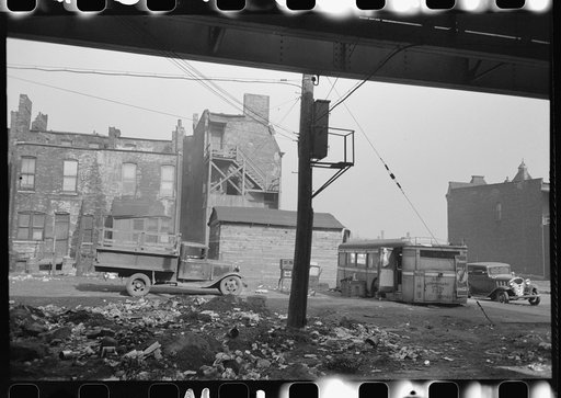 Lunch wagon and apartment house under the Elevated in the Negro section of Chicago, Illinois