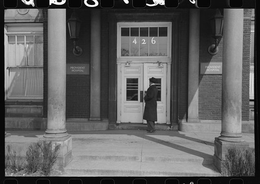 Doctor entering Provident Hospital, an all-Negro hospital in Chicago, Illinois