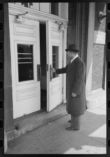 Doctor entering Provident Hospital, South Side of Chicago, Illinois