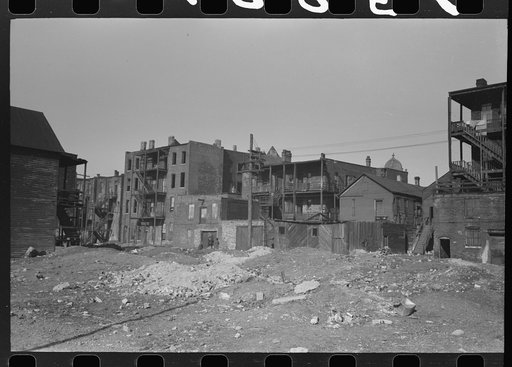 Vacant lot and apartment building in Negro section of Chicago, Illinois