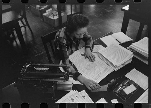 Negro working in insurance company office, South Side of Chicago, Illinois