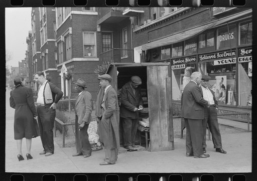 Activity around newsstand on street corner, Chicago, Illinois