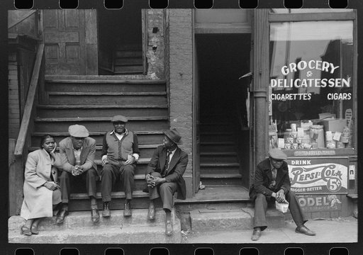 People sitting on front porches in Negro section of Chicago, Illinois
