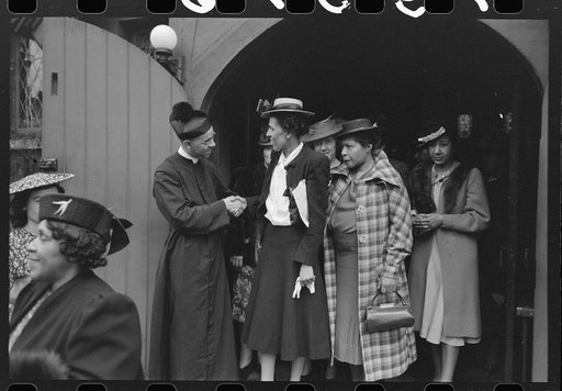 Shaking hands with members of the congregation after services at an Episcopal Church, South Side, Chicago, Illinois