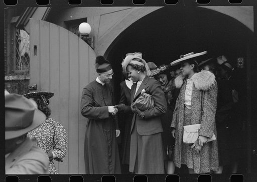 Shaking hands with members of the congregation after services at an Episcopal Church, South Side of Chicago, Illinois