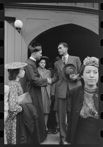 Shaking hands with members of the congregation after services at an Episcopal Church, South Side of Chicago, Illinois