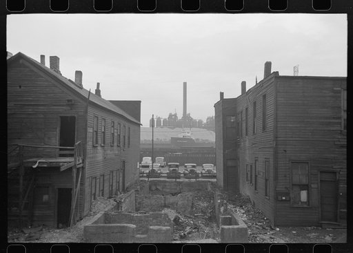 Condemned houses in Negro section of Chicago, Illinois, with steel mills in background