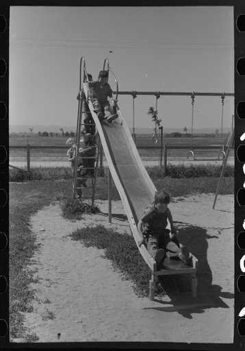 Untitled photo, possibly related to: Children playing on slide at FSA (Farm Security Administration) labor camp, Caldwell, Idaho