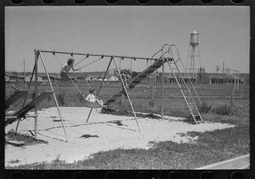 Untitled photo, possibly related to: Children playing on slide at FSA (Farm Security Administration) labor camp, Caldwell, Idaho