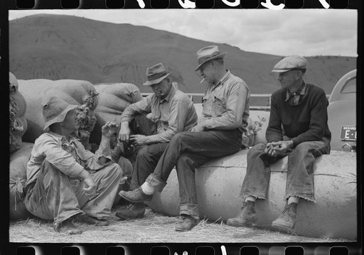 Sheep shearers and bags of wool in the background, Malheur County, Oregon