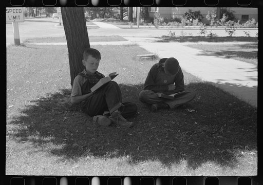 Boys read storybooks in the shade. Caldwell, Idaho