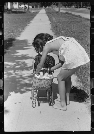 Little girl plays with her doll. Caldwell, Idaho