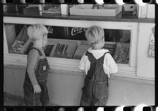 Untitled photo, possibly related to: Little boys deciding what kind of candy they want to buy. Caldwell, Idaho