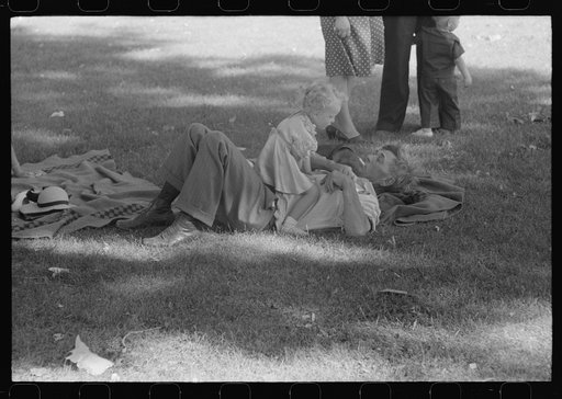 Farmer with his granddaughter at picnic on Fourth of July. Vale, Oregon