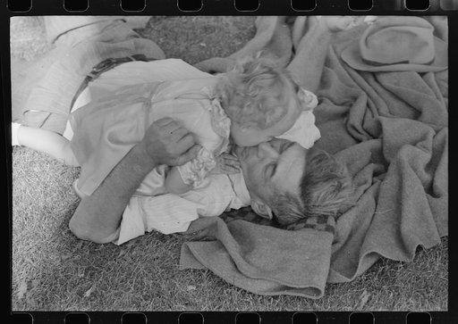 Untitled photo, possibly related to: Farmer with his granddaughter at picnic on Fourth of July. Vale, Oregon