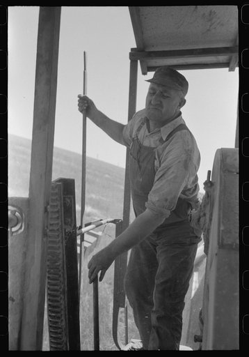 Walla Walla County, Washington. Working on a combine in a wheat field