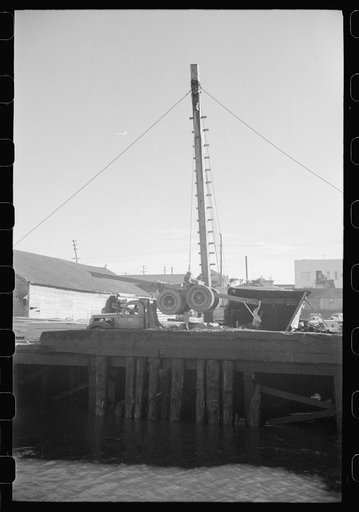 Untitled photo, possibly related to: Loading onto trailer truck, logging operations, Tillamook County, Oregon. The trailer is carried on the truck when it returns to the woods empty for more logs