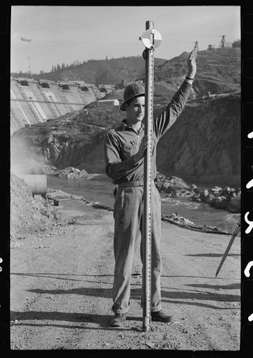 Rod man with surveying crew at Shasta Dam, Shasta County, California