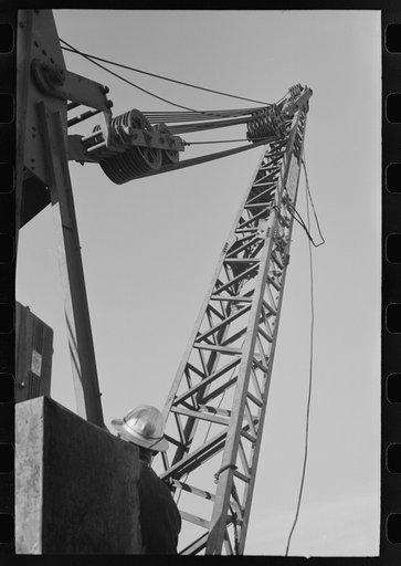Crane on top of central tower for handling repairs of carriage of buckets which deliver material to construction points at Shasta Dam, Shasta County, California