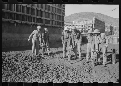 Untitled photo, possibly related to: Workmen using viberators which spread the wet concrete in construction of Shasta Dam, Shasta County, California