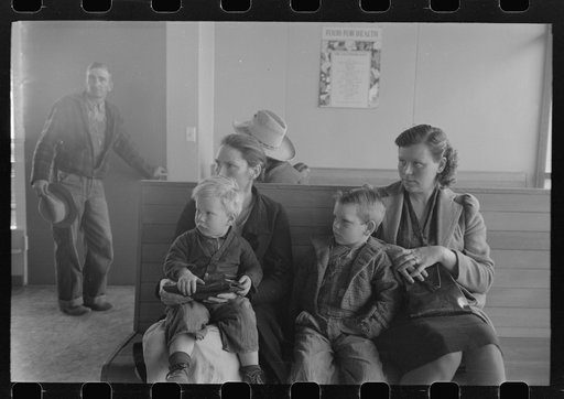 Agricultural workers wait in the clinic at the FSA (Farm Security Administration) farm workers community, Woodville, California