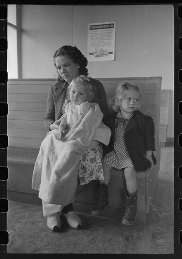 Agricultural workers wait in the clinic at the FSA (Farm Security Administration) farm workers community, Woodville, California