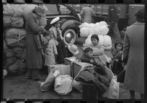 Los Angeles, California. The evacuation of the Japanese-Americans from West Coast areas under U.S. Army war emergency order. Waiting with their luggage at the old Santa Fe station for a train which will take them to Owens Valley