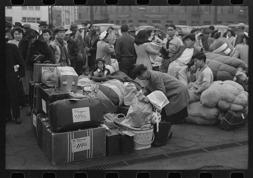 Untitled photo, possibly related to: Los Angeles, California. The evacuation of the Japanese-Americans from West Coast areas under U.S. Army war emergency order. Evacuees waiting with their luggage at the old Santa Fe station for a train to take them to Owens Valley
