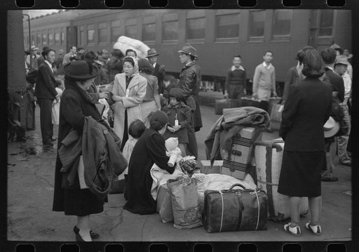 Untitled photo, possibly related to: Los Angeles, California. Japanese-American evacuation from West Coast areas under U.S. Army war emergency order. Waiting with their luggage at the old Santa Fe station for a train to take them to Owens Valley